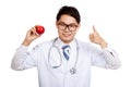 Asian male doctor thumbs up with apple
