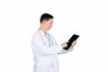 Asian male doctor using tablet computer writing in a medical record chart after medical treatment of patient Royalty Free Stock Photo