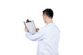 Asian male doctor writing on a medical record chart after medical treatment of patient Royalty Free Stock Photo