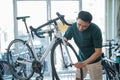 asian male employee assembles a new bike while working