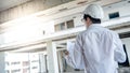 Asian male engineer checking blueprints at construction site Royalty Free Stock Photo