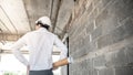 Asian male engineer holding blueprints at construction site Royalty Free Stock Photo