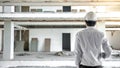 Asian male engineer holding blueprints at construction site Royalty Free Stock Photo