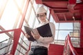 Asian male engineer holding files at construction site Royalty Free Stock Photo