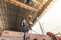 Male engineer controlling electric cable hoist