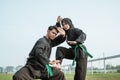 Asian male and female fighters wear pencak silat uniforms with stance formation poses