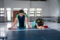 Asian male and female ping pong players get frustrated Royalty Free Stock Photo