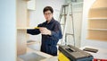 Asian male furniture assembler using tape measure Royalty Free Stock Photo