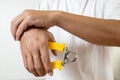 Asian male holding a spring hand grip for exercise,physical therapy or recovery,man patient doing hand finger and wrist exercise, Royalty Free Stock Photo