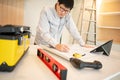 Asian male Interior worker working with architectural drawing Royalty Free Stock Photo