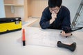 Asian male Interior worker working with architectural drawing Royalty Free Stock Photo