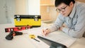 Asian male Interior worker working with architectural drawing Royalty Free Stock Photo