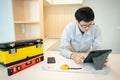 Asian male Interior worker working with architectural drawing Royalty Free Stock Photo