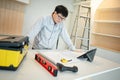 Asian male Interior worker working with architectural drawing Royalty Free Stock Photo