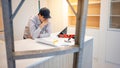 Asian male Interior worker working with architectural drawing Royalty Free Stock Photo