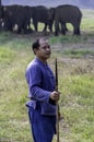 Asian male Mahout holding spear weapon for controlling elephants. Elephant trainer or Mahout for control order wild elephant in