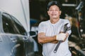 Asian male mechanic professional portrait happy smile work man in garage auto service Royalty Free Stock Photo