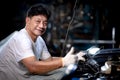 Asian male mechanic professional portrait happy smile work man in garage auto service Royalty Free Stock Photo