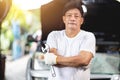 Asian male mechanic professional portrait happy smile work man in garage auto service Royalty Free Stock Photo