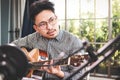 Asian male musician playing guitar in recording studio. Royalty Free Stock Photo