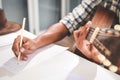 Asian male musicians sitting guitar instrument Acoustic and currently composing music. Royalty Free Stock Photo