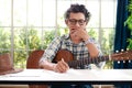 Asian male musicians sitting guitar instrument Acoustic and currently composing music. Royalty Free Stock Photo