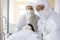 Asian male nurse and doctor wearing ppe suit and face mask pushing stretcher gurney bed with seriously infected coronavirus or Royalty Free Stock Photo