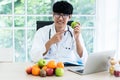 Asian male nutritionists are presenting green apples and fruit For health care