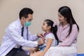 Asian male pediatrician hold stethoscope exam child boy patient visit doctor with mother Royalty Free Stock Photo