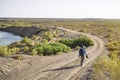 Asian male photographer walking in gobi desert Royalty Free Stock Photo