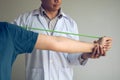 Asian male physical therapist descent working and helping to protect the hands of patients with patient doing stretching exercise Royalty Free Stock Photo