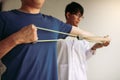 Asian male physical therapist descent working and helping to protect the hands of patients with patient doing stretching exercise Royalty Free Stock Photo