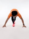 Asian male runner in start position ready to run, front view.High key studio shoot against white Royalty Free Stock Photo