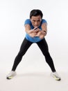 Asian male runner warming up prepararing his body before running workout. stretch his leg muscle, studio full length portrait Royalty Free Stock Photo