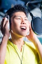 Asian male singer producing song in recording studio Royalty Free Stock Photo