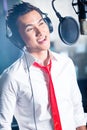 Asian male singer producing song in recording studio Royalty Free Stock Photo