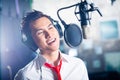 Asian male singer producing song in recording studio Royalty Free Stock Photo