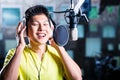 Asian male singer producing song in recording studio Royalty Free Stock Photo