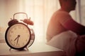 Asian male stretching out after woke up with alarm clock show Royalty Free Stock Photo