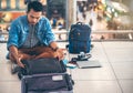 An Asian male traveler is experiencing the problem of need and l Royalty Free Stock Photo