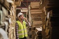 Asian male worker, supervisor talks with mobile phone at paper factory