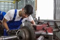 asian male workers brake disc grinder. repair and maintenance service automobile. Car auto part repair service center