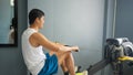 Asian men athlete doing situps exercise with machine to strengthen muscle for health care at gym stadium Royalty Free Stock Photo