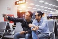 Asian man with backpack  traveler using the smart mobile phone for Video call and taking photo at an airport,Blurry and soft focus Royalty Free Stock Photo