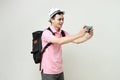 man backpacker take photo with mobile phone. digital nomad and travelling concept. on isolated background Royalty Free Stock Photo