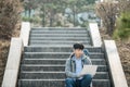 Asian man backpacking using laptop. Royalty Free Stock Photo