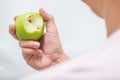 Asian man bite green apple and scurvy Royalty Free Stock Photo