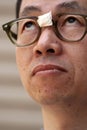 Asian Man in Broken Glasses Royalty Free Stock Photo