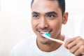 Asian man brushing teeth Royalty Free Stock Photo