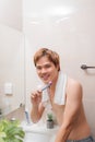 Asian man brushing teeth in the morning in bathroom Royalty Free Stock Photo